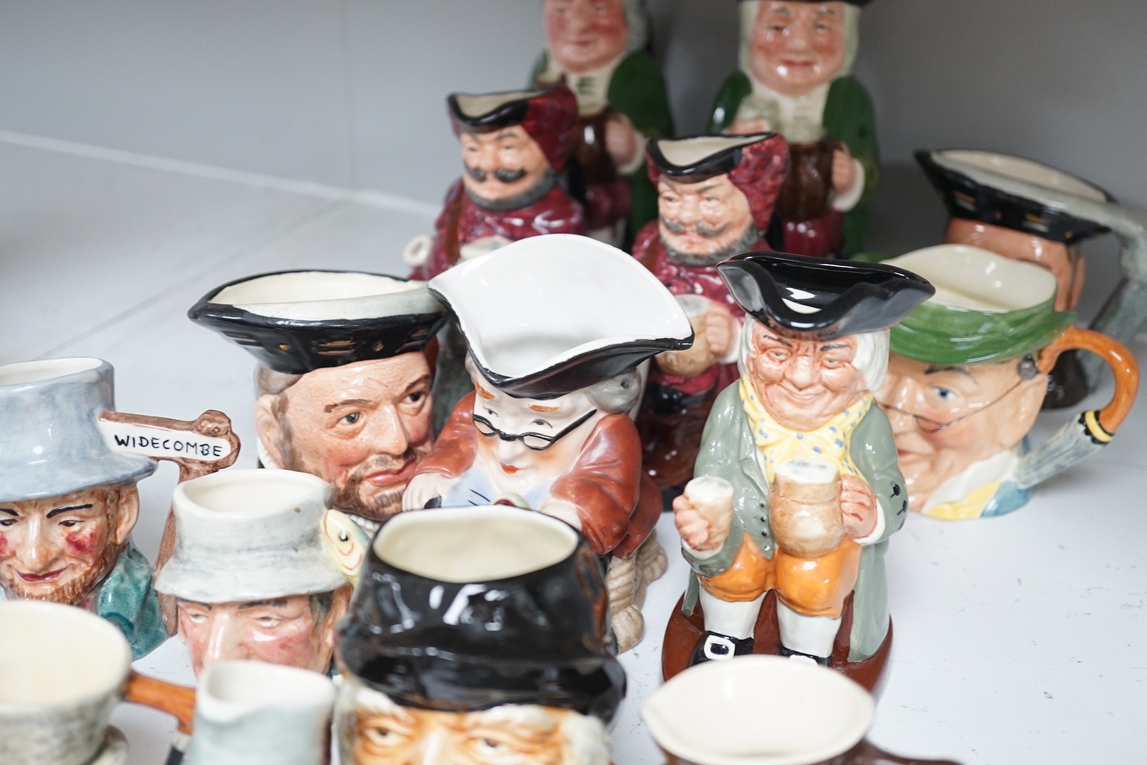 Five Royal Doulton toby jugs and a collection of similar toby jugs